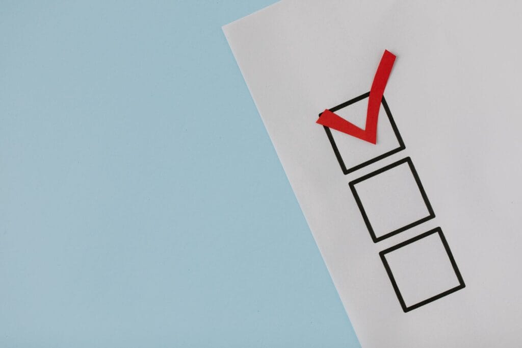 White paper checklist with a red checkmark representing evaluation criteria and red flags for mortgage lead vendors.