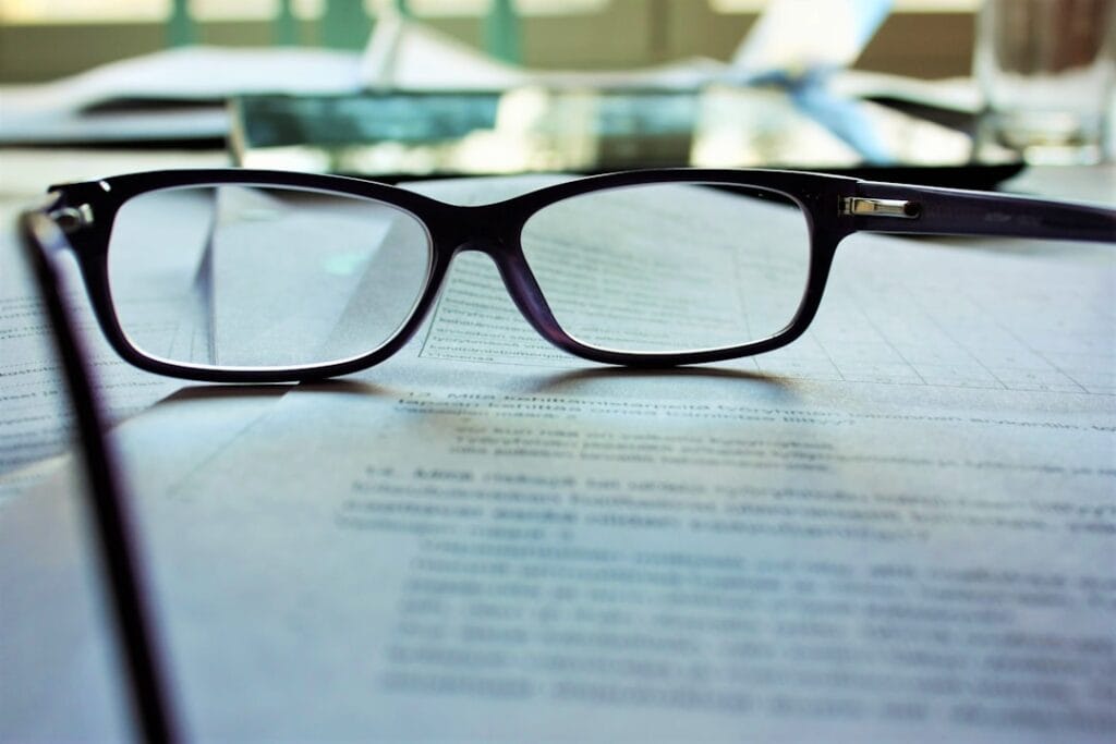 Reading glasses resting on a contract document — scrutinizing vendor exclusivity claims