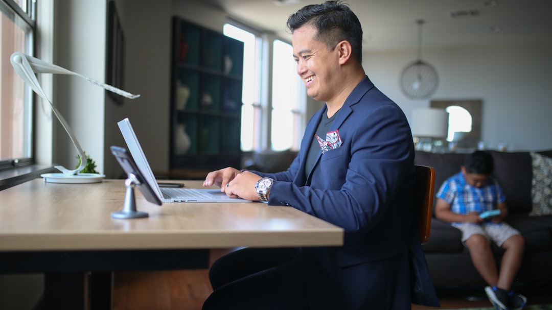 Mortgage loan officer working on laptop reviewing lead channel data and pipeline strategy